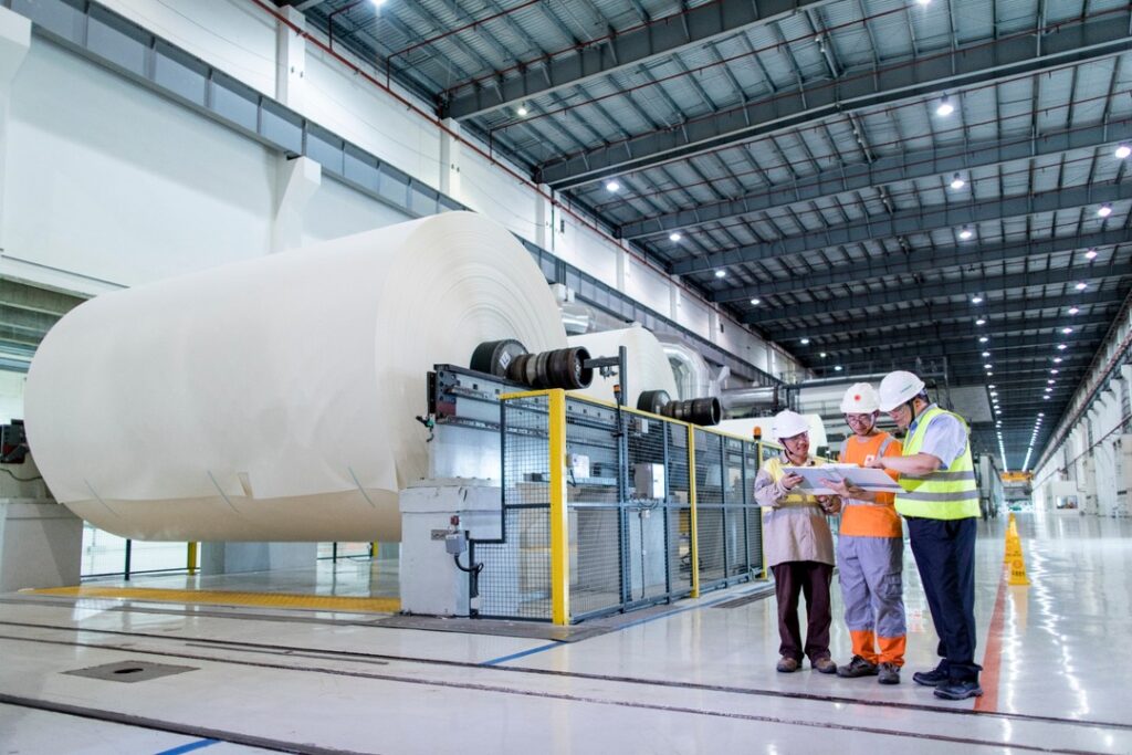 Mill managers reviewing bulk sodium hydroxide pearls inventory from Camachem.