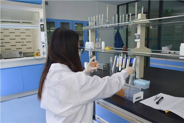 Laboratory technician conducting chemical analysis using testing equipment