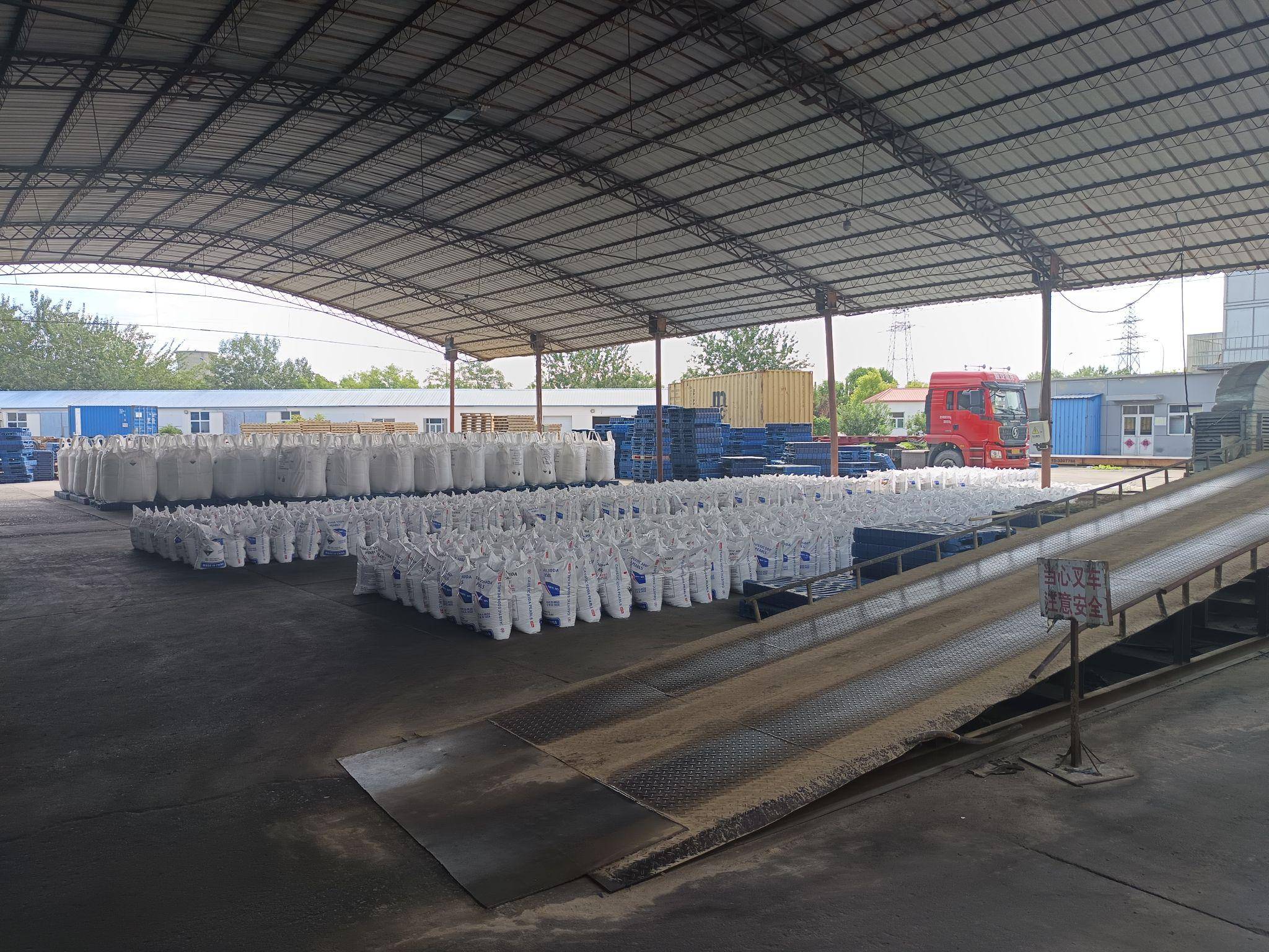 Caustic soda bags being loaded for industrial shipping at factory