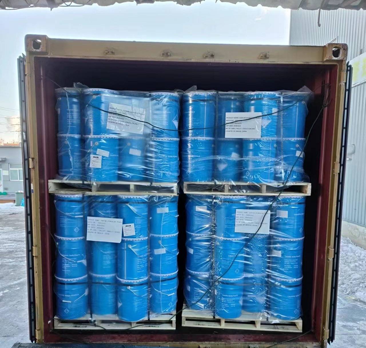 Caustic soda in 50kg steel drums, packaged and ready for international export, showcasing the efficiency of Chinese export-focused manufacturers.