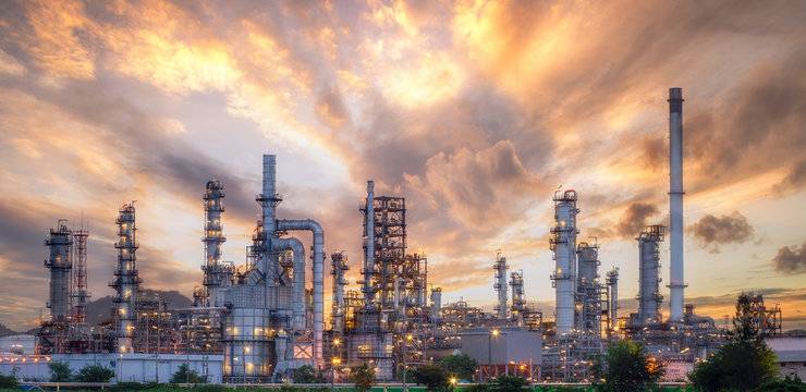 Panoramic view of an oil refinery at sunset