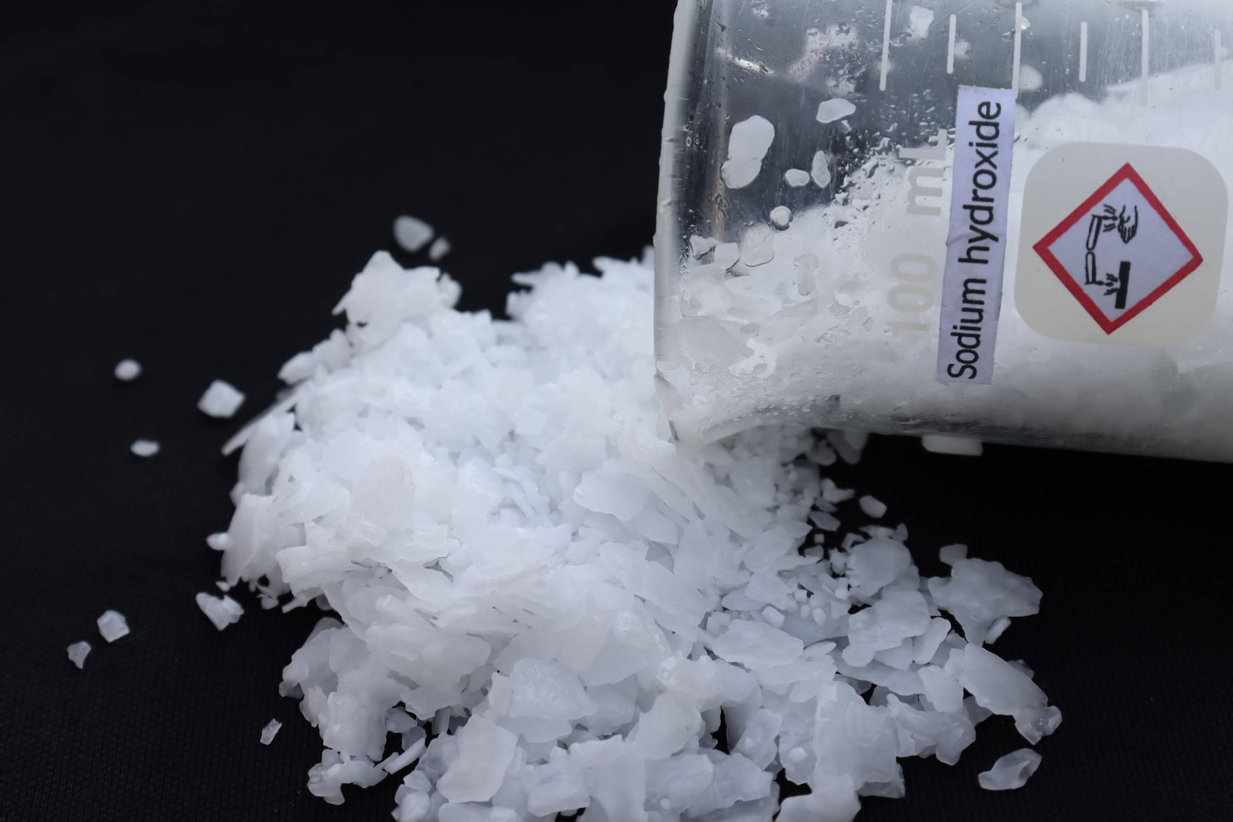 Sodium Hydroxide Solution vs Solid: What Bulk Users Need to Know (2026 Update) 3 Close-up view of high-purity caustic soda pearls, showcasing their uniform spherical shape.