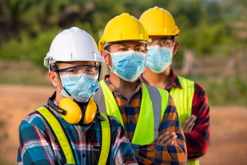 Sodium Hydroxide Solution vs Solid: What Bulk Users Need to Know (2026 Update) 4 Asian industrial workers in a chemical plant wearing safety gear, emphasizing safety in caustic soda handling.